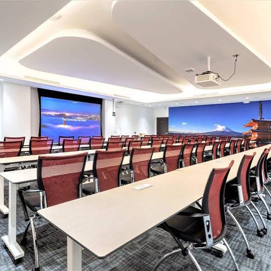 Workshop room at Jay Conference Center with classroom-style tables and screens